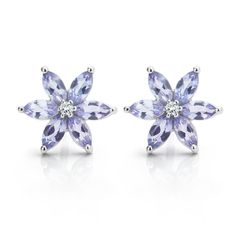 Discover the elegant beauty of the Tanzanite flower earrings. Each earring features a beautiful set of 6 x Marquise cut Tanzanites with a distinctive lilac-purple colour set into 9 carat White Gold. At the heart of each earring, a natural round brilliant cut diamond adds a little sparkle. The Tanzanite and diamond flower earrings are available online and from our UK showroom designs and are typically available from stock for speedy delivery. We present the completed earrings in a beautiful prese Classic Flower Earrings For Formal Occasions, Elegant Purple Flower Shaped Earrings, Elegant Purple Flower Earrings, Formal Sterling Silver Flower Cluster Earrings, Formal Flower Shape Sterling Silver Cluster Earrings, Elegant Lavender Flower Shaped Jewelry, Classic Flower Earrings For Pierced Ears, Classic Flower-shaped Earrings For Pierced Ears, Elegant Lavender Flower Jewelry