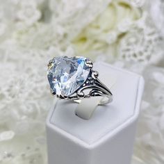 10ct. White CZ (Cubic Zirconia) 925 Sterling Silver RingHeart Leaf Design#D213 This Gothic inspired lovely filigree ring is set with a 10ct flawless White CZ (Cubic Zirconia) . This heart gemstone is 15mm x 15mm. The rings sits 11mm off the finger. Notice the beautiful gothic design of the silver filigree setting and band. The inside of the band is marked 925 for sterling silver. This is an exquisite rendition of an antique filigree ring. The sterling filigree cradles the stone in a delicate car Classic Crystal Ring, Elegant Cubic Zirconia Crystal Ring For Valentine's Day, Elegant Crystal Ring With Cubic Zirconia For Valentine's Day, Silver Heart Cut Jewelry For Formal Occasions, White Crystal Ring For Wedding On Valentine's Day, White Crystal Ring For Wedding And Valentine's Day, Heart Cut Cubic Zirconia Crystal Ring For Wedding, Cubic Zirconia Heart Cut Wedding Ring, Silver Pear-shaped Cubic Zirconia Wedding Ring