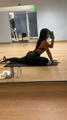 a woman laying on the floor taking a selfie