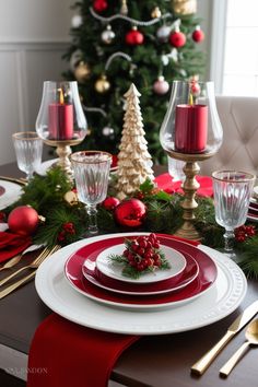 a christmas table setting with red and white plates