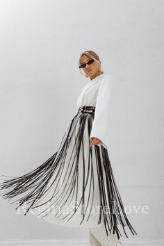 Step into the world of bohemian chic with our stunning Belt with Fringe. This fashion-forward accessory is the perfect addition to elevate your dress, accentuate your waist, and make a bold fashion statement. Crafted with care and attention to detail, this fringe belt exudes a sense of effortless style and adds a touch of flair to any outfit. Choose from an array of captivating colors to match your personal style and wardrobe. From classic black and timeless brown to vibrant red, feminine pink, Blue Fringe Belt, Elegant Party Skirt With Tassels, Long Skirt With Tassels For Spring, Spring Long Skirt With Tassels, Chic Skirt With Tassels For Spring, Chic Spring Skirt With Tassels, Chic Fringe Mini Skirt, White Belted Skirt For Spring, Spring White Skirt With Belt