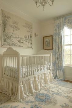 a white crib in front of a window with curtains