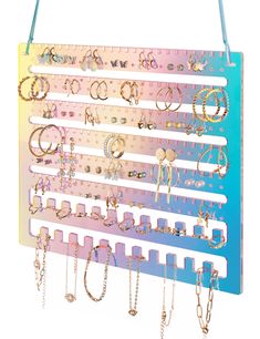 a wall mounted jewelry rack with multiple pairs of earrings hanging from it's sides