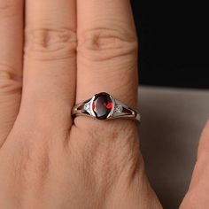 This is a gorgeous handmade creation. Its beauty is its simplicity & Elegance. The 6*8mm oval shape faceted natural garnet is crafted in solid sterling silver and with rhodium plated. All item is sent in a beautiful gift box If you have any idea of design your ring,pls contact me directly. You can realize more lovely stuff clicking the link https://www.etsy.com/shop/knightjewelry?refshopsection_shophome_leftnav Please leave the correct address and you phone number for delivering successfully Oval Garnet Birthstone Ring For Anniversary, Oval Garnet Rings For Anniversary, Oval Garnet Ruby Ring As Gift, Oval Garnet Birthstone Ring, Elegant Oval Garnet Birthstone Ring, Oval Garnet Birthstone Ring As Gift, Silver Garnet Engagement Ring, Oval Cabochon Garnet Rings For Anniversary, Oval Garnet Rings As Gift