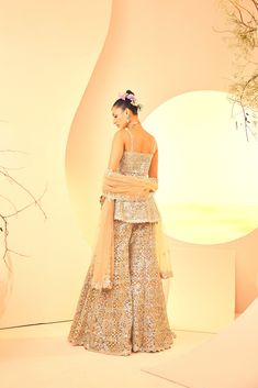 Showcasing a geometrical embroidered sharara and kurta with a dupatta. It is embroidered with gold foil and mirror embroidery. From Aneesh Agarwaal's Naksh collection. DELIVERY TIMEPlease allow 8-12 weeks for your outfit to arrive. FABRIC DETAILSTulle Professional cleaning only. Golden Sharara, Embroidered Sharara, Mirror Embroidery, 12 Weeks, Professional Cleaning, Gold Foil, Foil, Mirror, Embroidery