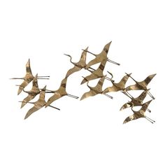 four metal birds are flying in the air