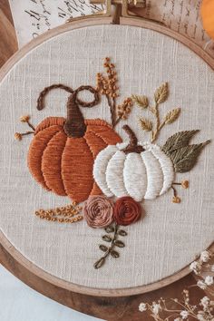 an embroidery project with pumpkins and flowers on it