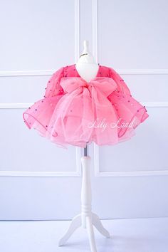 Looking for the perfect outfit for your little princess's special occasion? Look no further than our stunning Dress! Perfect for flower girls, birthdays, and other special occasions, this dress is sure to make your little girl feel like a true princess. Made with high-quality materials, this toddler dress is not only beautiful but also comfortable for your little one to wear. The soft and breathable fabric ensures that your baby girl will feel comfortable and happy all day long, whether she's po Spring Princess Tutu Dress With Bow, Spring Princess Style Tutu Dress With Bow, Party Princess Dress With Pink Bow, Pink Long Sleeve Princess Dress With Ruffles, Sweet Long Sleeve Party Dress, Pink Princess Dress For First Birthday In Spring, Spring Long Sleeve Tutu Dress For Pageant, Pink Bow Dress For Dress-up, Pink Princess Organza Dress