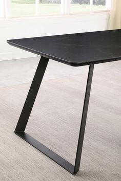 a black table sitting on top of a carpeted floor