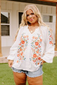 Plus Size - Dress for spring in our darling white 'Dune Dreaming' top featuring lightweight material with gorgeous blue, green, and red/orange hued embroidered floral detailing, a v-cut neckline with a tie closure, long loose sleeves with elastic band cuffs, and a relaxed silhouette that falls into a straight hemline! Measurements 1XL : Bust 50", Hip 52", Length 25", Sleeve Length 25.5", Waist 51". 2XL : Bust 52", Hip 54", Length 26", Sleeve Length 26", Waist 53". 3XL : Bust 54", Hip 56", Length V Cuts, Embroidered Top, Hip Length, Plus Size Dress, Length Sleeve, Floral Tops, Rompers, Sleeve Length, Plus Size