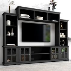 a black entertainment center with shelves and a flat screen tv mounted on it's side