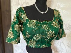 Bottle green Pure silk blouse  blouse- with hand embroidered designs on neck and sleeve . sleeve -11 inches. well made blouses begins size 36 goes up to 44 . Lined padded blouses. Ships from Texas 💐 Blouses comes fully stitched lined with back ties depending on the style - Alterations can be requested . Blouse comes at size 36 - and we can alter them upto 42/43.  Fall Pico done . Video calls can be requested. Green Art Silk Blouse For Wedding, Fitted Green Embroidered Traditional Wear, Elegant Green Art Silk Blouse, Green Tops With Resham Embroidery For Wedding, Green Resham Embroidered Top For Wedding, Short Sleeve Green Blouse For Festivals, Fitted Green Top For Diwali, Elegant Art Silk Blouse With Floral Embroidery, Elegant Embroidered Art Silk Blouse