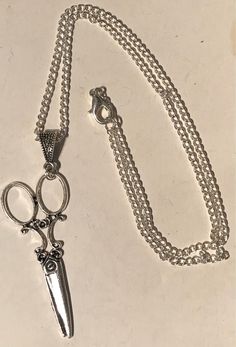 Large scissor necklace tibetan silver scissors  On a 20inch silver plated chain With a lobster clasp fastening Length of scissors 6cm Scissor Necklace, Photo Mask, Stocking Filler, Stocking Fillers, Secret Santa, Pendant Necklaces, Lobster Clasp, Arrow Necklace, Jewelry Necklace Pendant