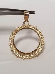 "Thanks for shopping our vintage estate store. We tend to sell well below wholesale and truly hope you enjoy all of our items. Many of the items are one of a kind, so please enjoy scrolling through the pictures and hopefully something will catch your eye. Spots are from reflection or camera. Estate 14k yellow gold bezel holder 1/10-coin rope twist pendant. Works great with any 1/10 gold coins. Length: 1 1/8\" Diam: 3/4\" Weight: 2.34 grams Bail: 3mm Nice 14k coin bezel pendant." Classic Intricate 14k Gold Jewelry, Antique White Gold Round Necklace, Antique Round White Gold Necklace, Collectible Yellow Gold Filigree Necklaces, Yellow Gold Filigree Necklaces, Vintage Gold Round Jewelry, Vintage Round Gold Jewelry, Victorian 14k Gold Jewelry With Bezel Setting, Victorian Style Yellow Gold Round Jewelry