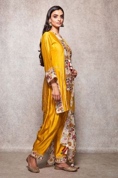 Mustard kurta with all-over floral embroidery and round neck. Comes with salwar and embroidered dupatta.
Component: 3
Embroidered
Neckline: Round
Sleeve Length: Full
Fabric: Cotton, Kota Doria
Color: Yellow
Embroidery at the sleeves and hem of the salwar
Straight fit kurta
Tie-up at the neck with tassels
Scallop hem dupatta
Tassels on the dupatta - Aza Fashions Dupatta Tassels, Yellow Embroidery, Kurta Set For Women, Scallop Hem, Embroidered Dupatta, Embroidered Neckline, Fashion App, Kurta Set, Scalloped Hem