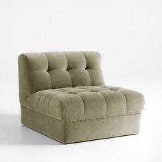 an image of a couch that is in the middle of a white room with no one on it