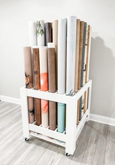 a white shelf with many different types of books on it