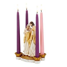 a statue of the virgin mary and child jesus surrounded by three pillar candles with gold trimmings