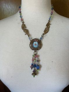 "OOAK Neo-Victorian Pastel Pendant Choker Necklace, Vintage Watch Face, Handmade Dangles This choker style Neo-Victorian necklace is so feminine with pretty pastel crystal beads, vintage stampings, as well as a pale blue vintage watch face inside a vintage filigree. All handmade. Closes with a large hook clasp in back. Chain 6\" Pendant 4\" Total length 13\" Many of my necklaces have chains that can be adjusted for length. Just message me and ask. If it's possible, I'm happy to do so. Oh, please Affordable Handmade Vintage Choker, Festival Vintage Charm Metal Necklaces, Vintage Medallion Jewelry For Festival, Vintage Medallion Jewelry For Festivals, Nickel-free Metal Victorian Necklace, Vintage Festival Medallion Jewelry, Unique Vintage Charm Metal Necklaces, Vintage Round Pendant Jewelry For Festivals, Vintage Festival Necklace With Vintage Charm