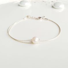 "Minimalist, wearable and delicate 925 sterling silver chain bracelet with natural pearl gemstone for everyday wearing. Length: from 5,5\" to 8\" with 2\" 925 sterling silver extensor chain. Width: 6-7mm single irregular pearl. Material: 925 sterling silver chain and strong lobster clasp. Handmade in Spain. Ideal for a gift to silver jewelry lovers. All our products are presented in a white organza bag. If you want a different color scheme, ask us and we will design it for you :) ♡ Made with lov Hypoallergenic Sterling Silver Pearl Bracelet, Minimalist Sterling Silver Pearl Chain Bracelet, Minimalist Sterling Silver Pearl Bracelet With Charm, Dainty Silver Bracelet With Pearl Chain, Dainty Sterling Silver Bracelets With Pearl Charm, Adjustable Sterling Silver Pearl Charm Bracelet, Minimalist Silver Pearl Bracelet With Adjustable Chain, Adjustable Delicate Sterling Silver Bracelet As A Gift, Silver Pearl Chain Bracelet As Gift