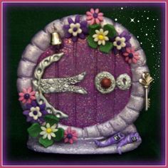 an image of a purple door decorated with flowers and keys in the shape of a face