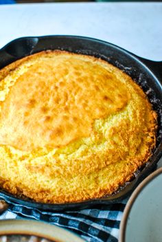 a skillet with some food in it on the stove top next to other cooking utensils