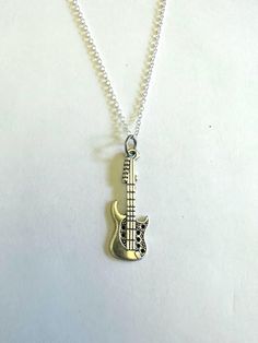 Guitar Charm Necklace. Silver tone finish. Lightweight and easy to wear. 24 inch chain. Guitar Necklace, Charm Necklace Silver, List Ideas, How To Get Money, Charleston Sc, Necklace Silver, Pendant Necklaces, Charleston, Charm Necklace