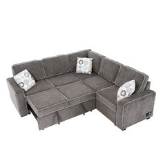 a gray sectional sofa with pillows on it