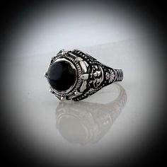 Our Version of the ring Johnny Depp wore in the movie Dark Shadows but we have made it in all sterling silver with a Black Onyx Stone set into the ring. Face of Ring is 20 mm wide by 18 mm high Set with a genuine Black Onyx Stone. Made in our studio by our own skilled silversmith artisans it has been oxidized to give it an antique look. We make to size so you need to provide us with your ring size in US or UK. Delivery is by DHL Express included in price. It takes around 10 to 14 days to make th Gothic Silver Stainless Steel Ring, Gothic Black Stainless Steel Rings, Black Skull Ring With Open Design As Gift, Black Open Skull Ring As A Gift, Gothic Engraved Rings For Anniversary, Black Gothic Collectible Rings, Victorian Style Black Sterling Silver Rings, Victorian Black Sterling Silver Rings, Formal Cabochon Sterling Silver Rings