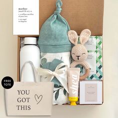 the baby gift box contains items such as a bottle, bib and diaper