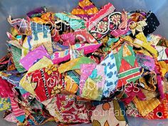 a pile of colorful scarves sitting on top of a plastic container