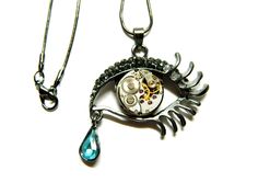 "The Devils tear of Time unique surprise gift. Black silver or silver or golden colored metal Eye, handmade decorated steampunk necklace, including mechanism of Russian watch (old clockwork) and big blue or green crystal. Pendant: 1 1/2\" x 2\" / 4 cm x 5 cm Length of the \"snake\" chain around 24\" / 60 cm just like in the first pictures, or ordinary small oval cable chain 24\" / 60 cm max Steam punk jewellery necklace The Blue Tear of Time, black silver colored pendant Eye, unique surprise gif Punk Jewellery, Black Steampunk, Watch Old, Steampunk Jewellery, The Devils, Steam Punk Jewelry, Protection Amulet, Steampunk Necklace, Gifts For Hunters