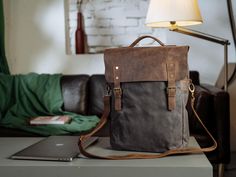 This is a backpack made of waxed canvas and full-grain leather. It has plenty of space inside, with multiple pockets and a special compartment for your laptop. Leather Messenger Bag, Waxed Canvas, Leather Messenger, Backpack Purse, Full Grain Leather, Romania, Bag Making, Water Repellent, Messenger Bag