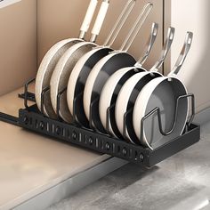 there are many black and white dishes in the dish rack