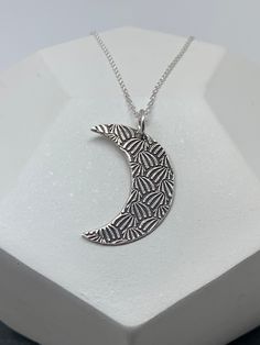 This unique silver moon necklace has been entirely handmade using .999 fine silver. It has been cut from fine silver precious metal clay, textured, fired and oxidized. The pendant hangs from a sterling silver diamond cut cable chain. This fine silver pendant features an embossed textured print pattern and hangs 1 1/4 from top of ring to bottom of the moon shape. Pendant size: approximately 1 x 3/4 inches Chain length: adjustable at 16 and 18 inches can also be customized to whatever length neede Boho Couches, Silver Moon Necklace, Moon Necklace Silver, Vertical Bar Necklace, Contemporary Necklace, Precious Metal Clay, Moon Shape, Silver Moon, Sterling Silver Flowers