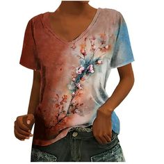 a woman is wearing a t - shirt with flowers on it