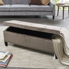 a bench sitting on top of a rug next to a couch