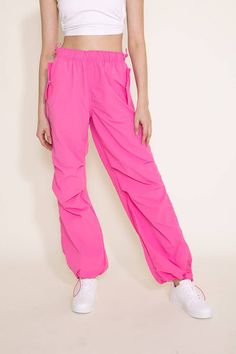 Step up your athletic game this with these Love Tree Nylon Baggy Parachute Pants for Women in Pink. These pants feature a comfy parachute design, elastic waistband, and side pockets to keep you comfortable all day long. These are going to be your new favorite pair of pants! Features: Love Tree Style: 6853PH-PINK Color: Pink 100% Nylon Women’s pants Side pockets Elastic waistband Moisture wicking Measurements from size small: Waist: 26” Front Rise: 11” Back rise: 13” Inseam: 31" Machine wash cold Trendy Sports Sweatpants With Elastic Waistband, Pink Relaxed Fit Parachute Pants With Side Pockets, Nylon Long Pants With Functional Drawstring, Solid Nylon Activewear With Elastic Waistband, Nylon Relaxed Fit Sweatpants For Athleisure, Moisture-wicking Nylon Techwear Bottoms, Functional Nylon Joggers With Elastic Waistband, Nylon Techwear Pants With Functional Drawstring, Trendy Sports Joggers With Elastic Waistband