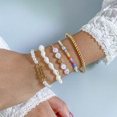 Crafted from pearl, howling and shell, these bracelets beautifully complement your favorite ensembles. Includes 18k gold-plated and white '1999' bracelet, white shell bracelet, pink and white 'love' bracelet, orange and blue beaded bracelet and 18k gold-plated bangle (five bracelets total) Full graphic text 18k gold-plated and white '1999' bracelet): 1999. Full graphic text (pink and white 'love' bracelet): Love. Lobster claw clasp 18k gold-plated copper / acrylic / teal howlite / pearl / shell Blue Beaded Bracelets, Shell Bracelet, Pearl Shell, Love Bracelets, White Pearl, Delicate Bracelet, Pink And White, Bracelet Set, Pearl White