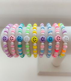 the bracelets are decorated with different colored beads and smiley faces on each bead