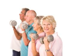 older people exercising with dumbbells in front of an elderly man and woman on a white background