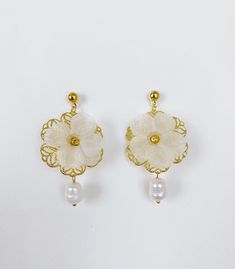 *Use discount FOURITEMS to get 10% off when you purchase 4 or more items (valid with jewelry, ceremony item, etc) * Designed and handcrafted in the Philippines by Filipino women artisans * Gold-plated brass studs with secure lock backs * Made of stainless steel gold plated hardware, handcrafted silk organza flowers characterized with sheerness that complements one's elegance, and baroque South Sea pearls, locally sourced from Cebu City in the Philippines to support traditional crafts * 2 inches in length, lightweight to wear all day * Each piece features 'intentional imperfections' - variations in exact size, cut, color, texture, and patterns. This adds to the individuality and unique story of each piece. Pearls are baroque and irregularly shaped, just as nature intended and may not exactl