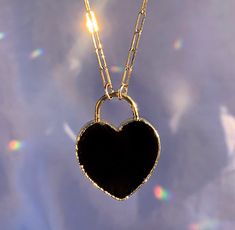 This adorable necklace features a heart shaped black onyx stone that has been electroformed in gold or silver and hangs from your choice of 14k gold filled or sterling silver drawn cable chain. Stones natural and each is one of a kind. Each will vary slightly since they are natural, but will be just under 1 inch. Necklace is adjustable and can be worn anywhere from 15 to 18 inches. Every item arrives in a lovely little gift box. 😘 Thanks for stopping by! ❤️ xoxo, Amy Elegant Black Heart Necklace With Adjustable Chain, Black Open Heart Jewelry For Valentine's Day, Elegant Black Charm Necklace, Minimalist Black Heart Jewelry, Minimalist Black Heart-shaped Jewelry, Valentine's Day Black Open Heart Jewelry, Black Heart Charm Pendant Necklace, Black Heart-shaped Jewelry, Black Round Pendant Jewelry For Valentine's Day