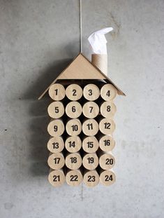 a house shaped clock made out of wood with numbers on the front and back side