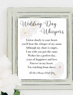 a wedding day poem is displayed in a frame with flowers on the table next to it