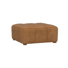 a brown leather ottoman sitting on top of a white floor