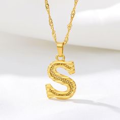 This necklace is the perfect addition to your jewelry collection or gift for a loved one. Choose any letter from A to Z! Chain Length: 17 inches (43 cm) Pendant Size: 0.55 inches (1.4 cm) Material: Stainless Steel Initial Letter Necklace, Alphabet Pendant, Gold Letter Necklace, Letter Pendant Necklace, Personalized Pendant, Gold Initial, Birthday Jewelry Gift, Letter Pendants, Gold Letters