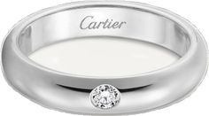 a white gold ring with a diamond in the center and a name engraved on it