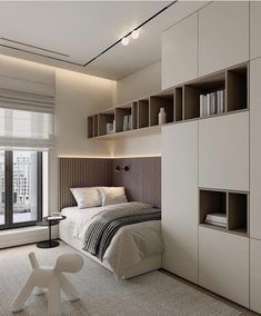 a bedroom with a bed, bookshelf and window in the corner next to it