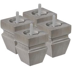 four concrete blocks with screws in them